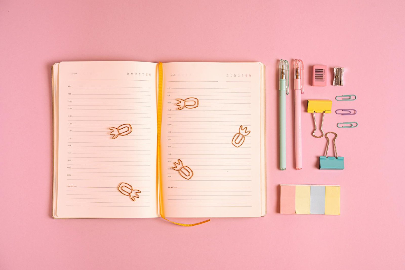 office supplies on pink background